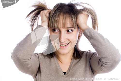 Image of Pretty woman with hands in hair