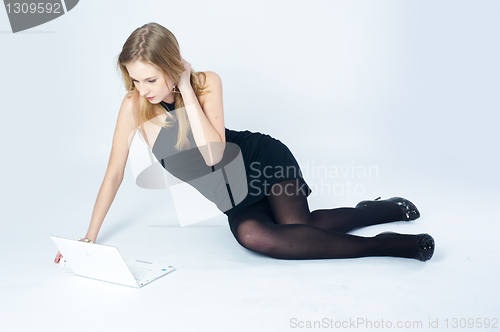 Image of Attractive blonde girl with laptop