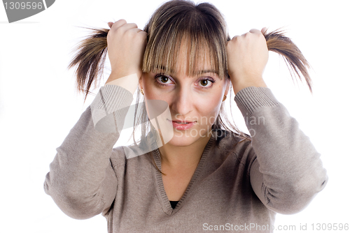Image of Pretty woman with hands in hair
