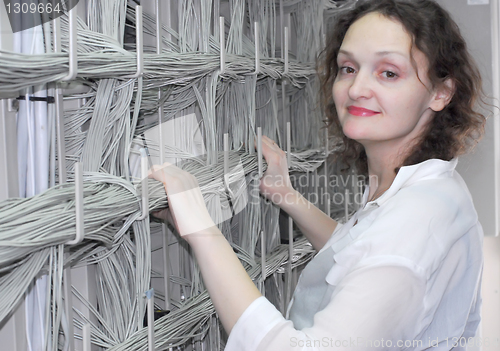 Image of Woman working on telecommunication equipment