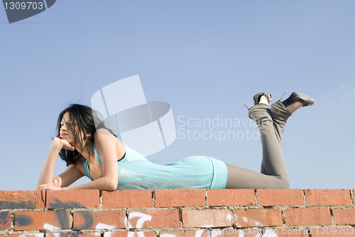 Image of Young woman on roof