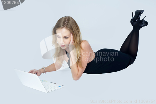 Image of Attractive blonde girl with laptop