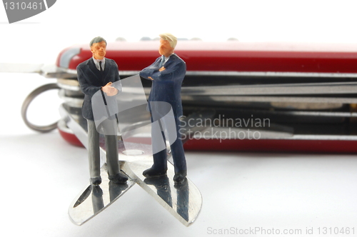 Image of business people on penknife