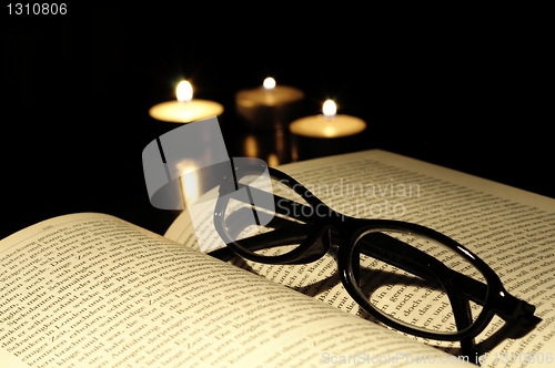 Image of book candle and glasses