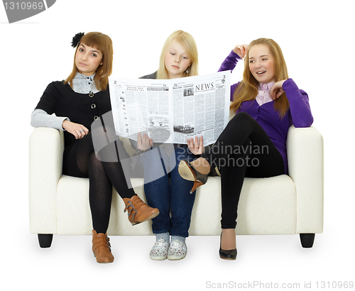 Image of Funny girl teenagers read newspaper