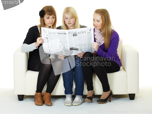 Image of Young girl reading newspaper