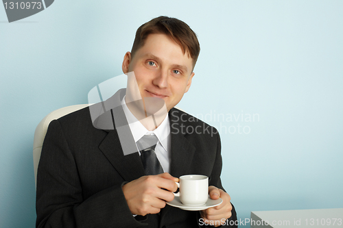 Image of Handsome businessman drinking coffee