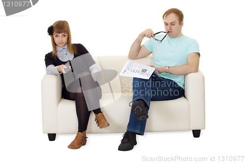 Image of Father reading newspaper, daughter watching TV