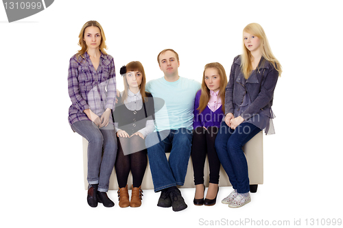 Image of An ordinary large family sitting on couch