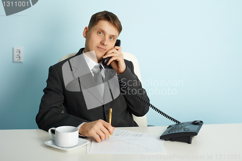 Image of Ordinary official in office - talking on phone