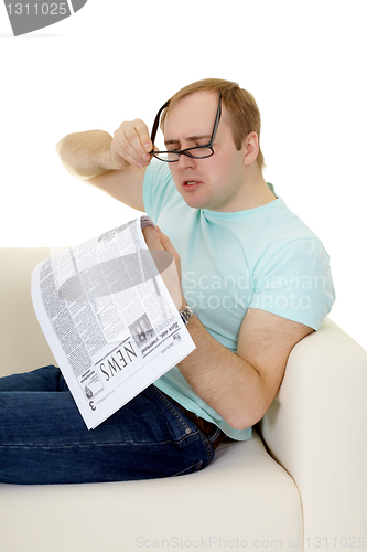 Image of Funny man reading a job advertisement in newspaper