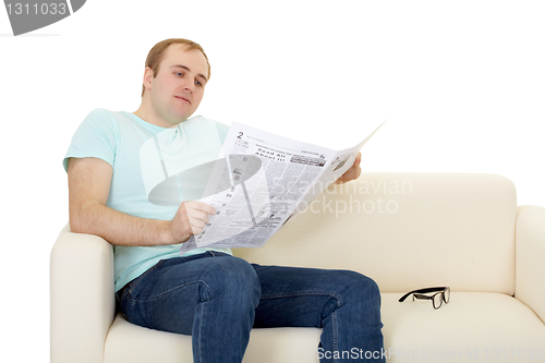 Image of Man reads newspaper