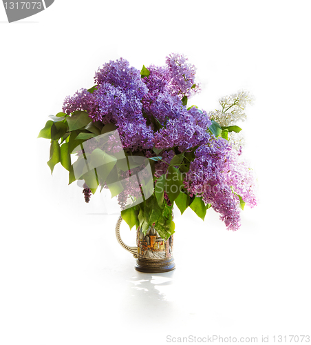 Image of Bouquet of a lilac in a bright jar on light tones.