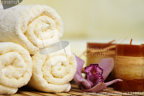 Image of Still-life from towels and candles on bamboo mat