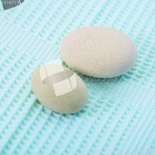 Image of Two small round stone on towel