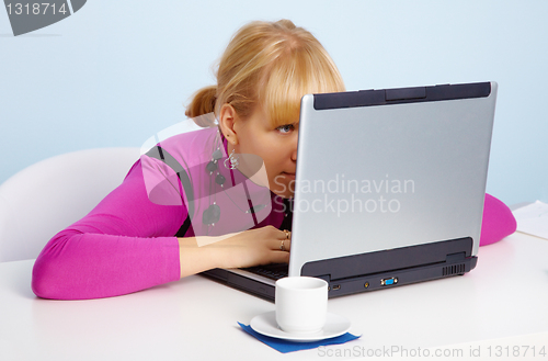 Image of Young girl - is looking closely at laptop monitor