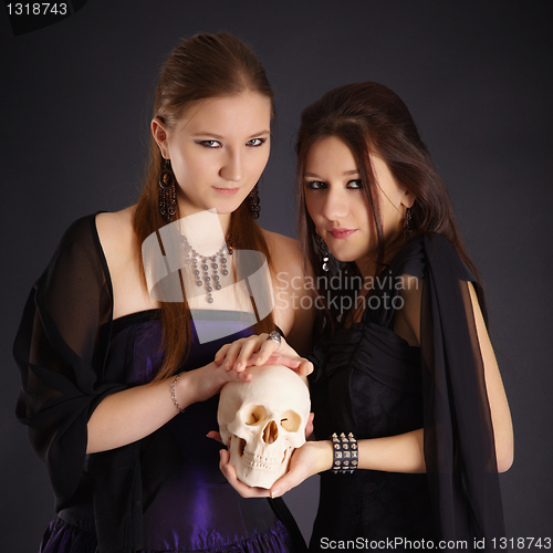 Image of Two young girls with a human skull