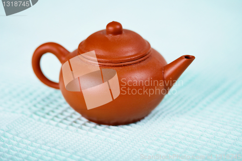 Image of Old brown ceramic pot on towel