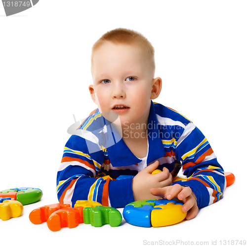 Image of Little boy with color toys on white