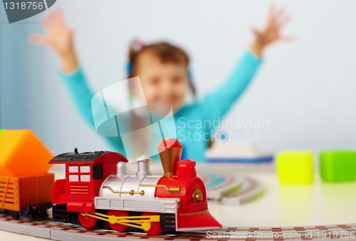 Image of Happy child playing with railway