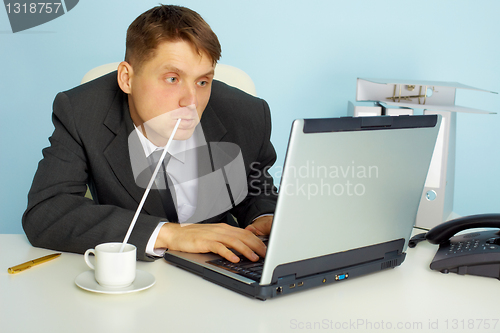 Image of a very busy man working with laptop