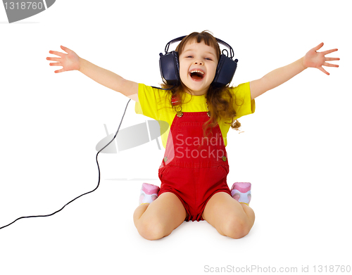 Image of Happy girl listens to music with headphones