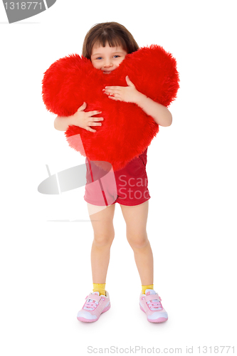 Image of Little girl hugging a toy heart on a white