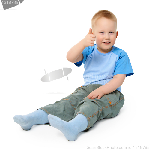 Image of Little boy sits on white background showing a gesture