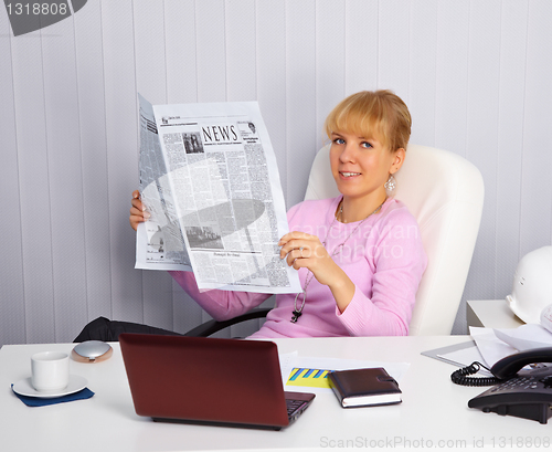 Image of Young woman reads news on the workplace
