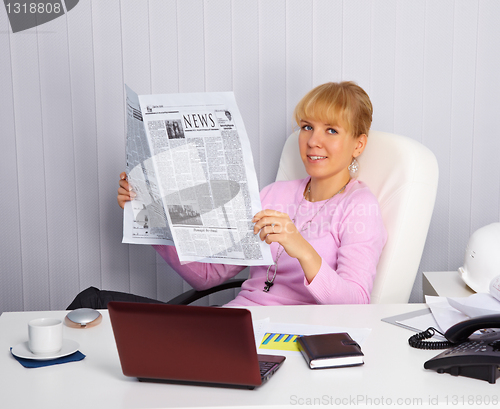 Image of Young woman reads news on the workplace