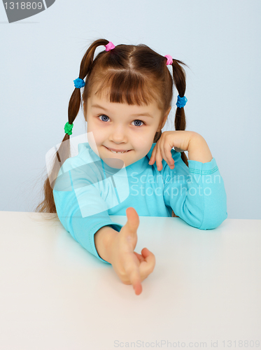 Image of Funny little girl shows a finger