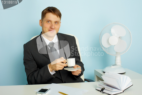 Image of Attractive young man with a cup of coffee