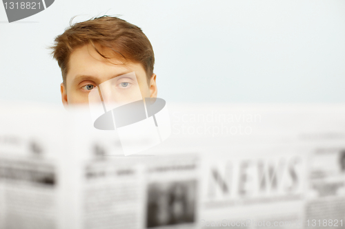 Image of Young man reads the newspaper