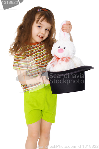 Image of Child gets rabbit out of a hat like magician on white