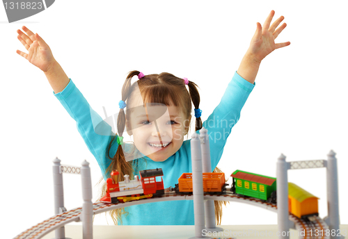 Image of Joyful girl playing with toy railway
