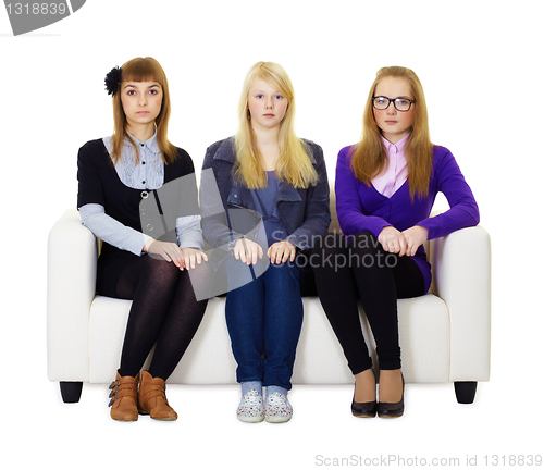 Image of Three girls teen sitting on the couch