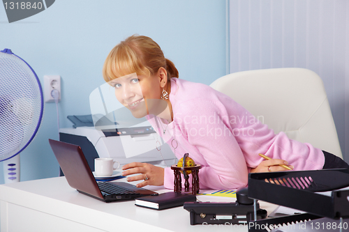 Image of Beautiful smiling young girl in office