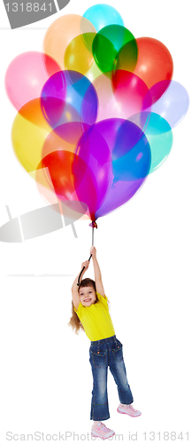 Image of Little girl is flying on bunch of balloons