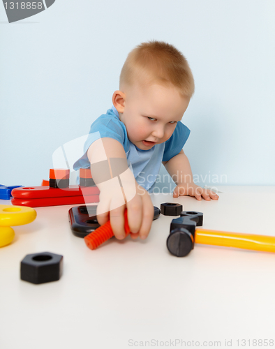 Image of Child playing with a toy plastic constructor