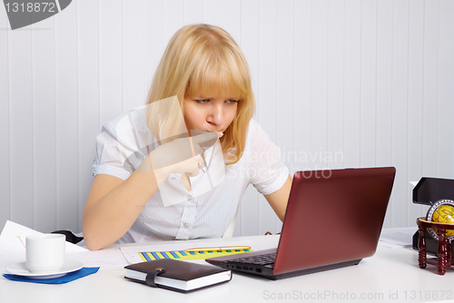 Image of Young woman working in office