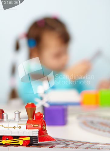 Image of Child playing with toy railway