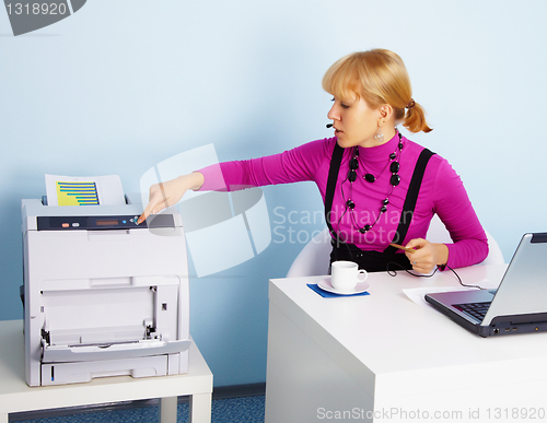 Image of Young woman - secretary prints out a document