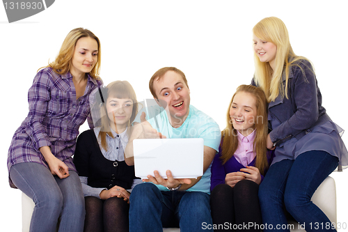 Image of large family with a laptop