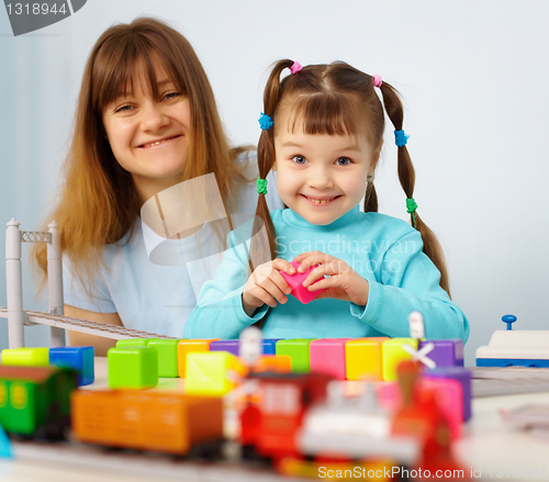 Image of Mother and daughter playing with toys