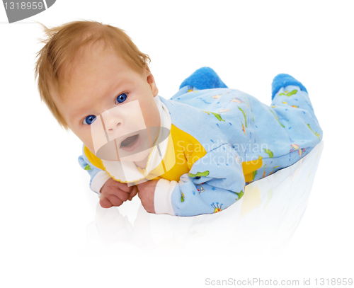 Image of Six months child lying on floor isolated on white