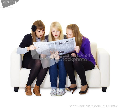Image of Three girlfriends teen read the newspaper