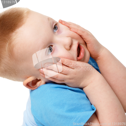 Image of Little boy emotionally grabbed hold of face
