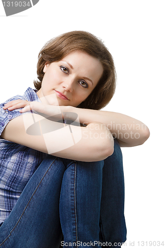 Image of attractive girl in jeans and a blue plaid blouse