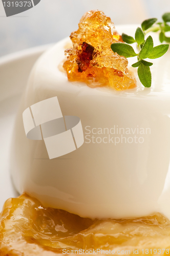 Image of Vanilla Panna Cotta Dessert with lemon and fresh herbs