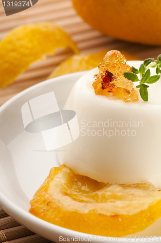 Image of Vanilla Panna Cotta Dessert with lemon and fresh herbs